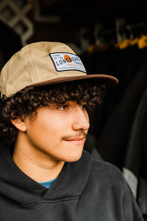 Moment The Classic 5 Panel Hat - Khaki / Brown on a model looking to the side.
