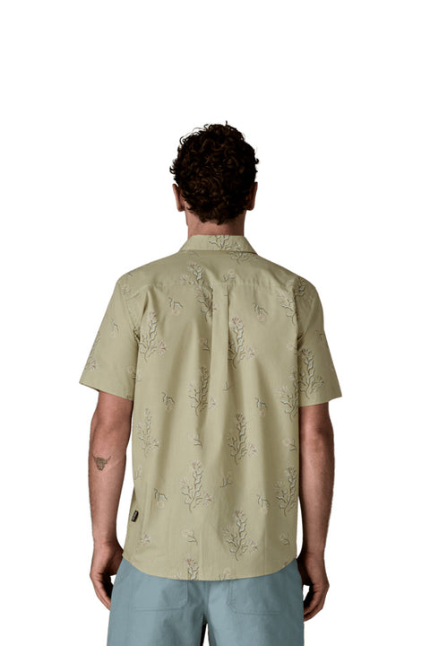 Man wearing a light green patterned shirt on a white background