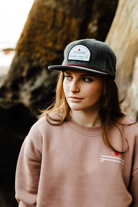 A model wearing the Moment Board Stack Corduroy Hat.