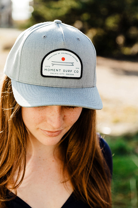 The Moment Board Stack 5 Panel Hat - Grey on a model looking down.