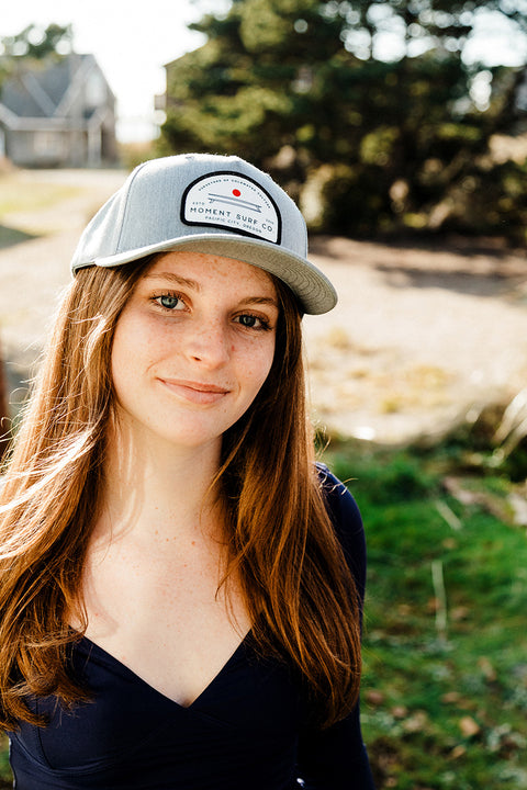 The Moment Board Stack 5 Panel Hat on a model.