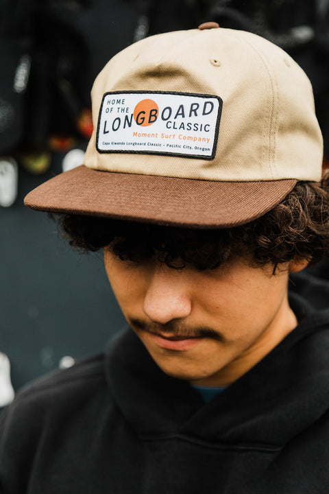 Moment The Classic 5 Panel Hat - Khaki / Brown on a model looking toward the ground