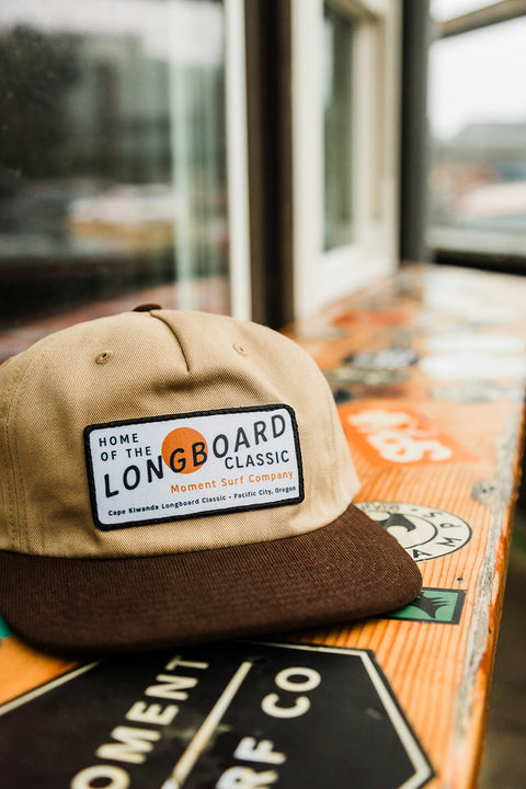 Moment The Classic 5 Panel Hat - Khaki / Brown on a bar top