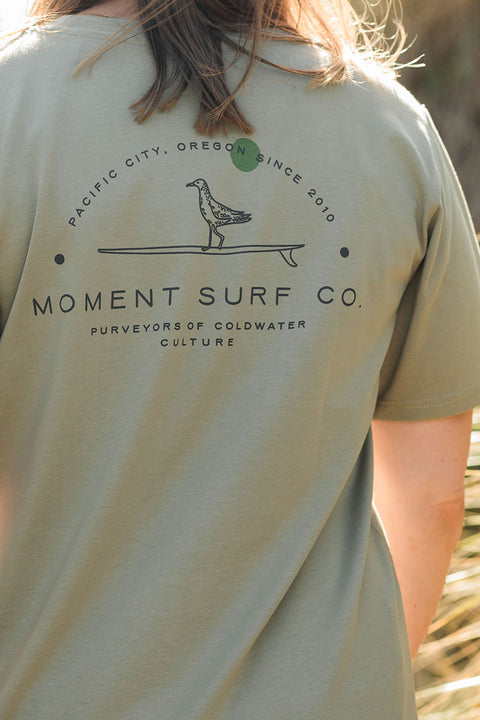Person wearing the Moment Women's Lt Dan T-Shirt facing away from the camera.