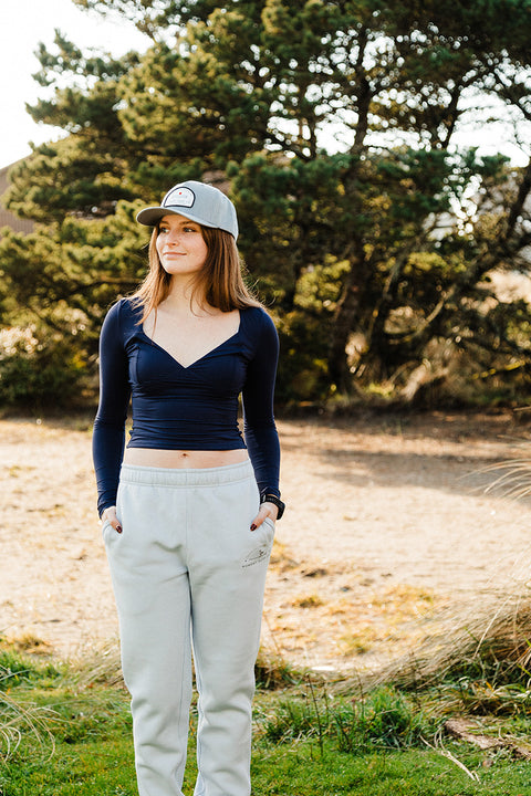 A model wearing the Moment Women's Lt. Dan Sweatpant looking to her right.