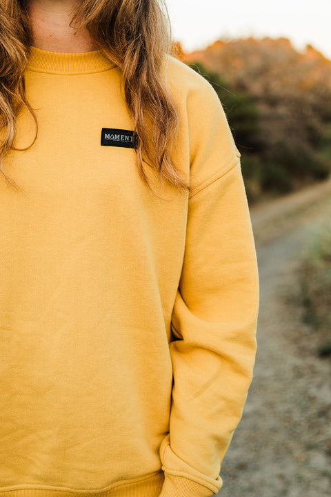 Moment Women's Sunset Pullover Crew - Gold - Closeup Front Chest