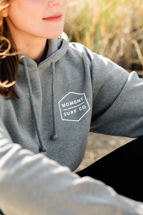 Closeup of the Moment Boxed Topo Logo Pullover Hoodie - Gunmetal Heather's front design.